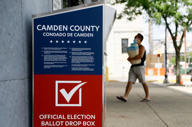 Man walks past a vote-by-mail drop box for the upcoming New Jersey primary election outside the Camden, N.J., Administration Building